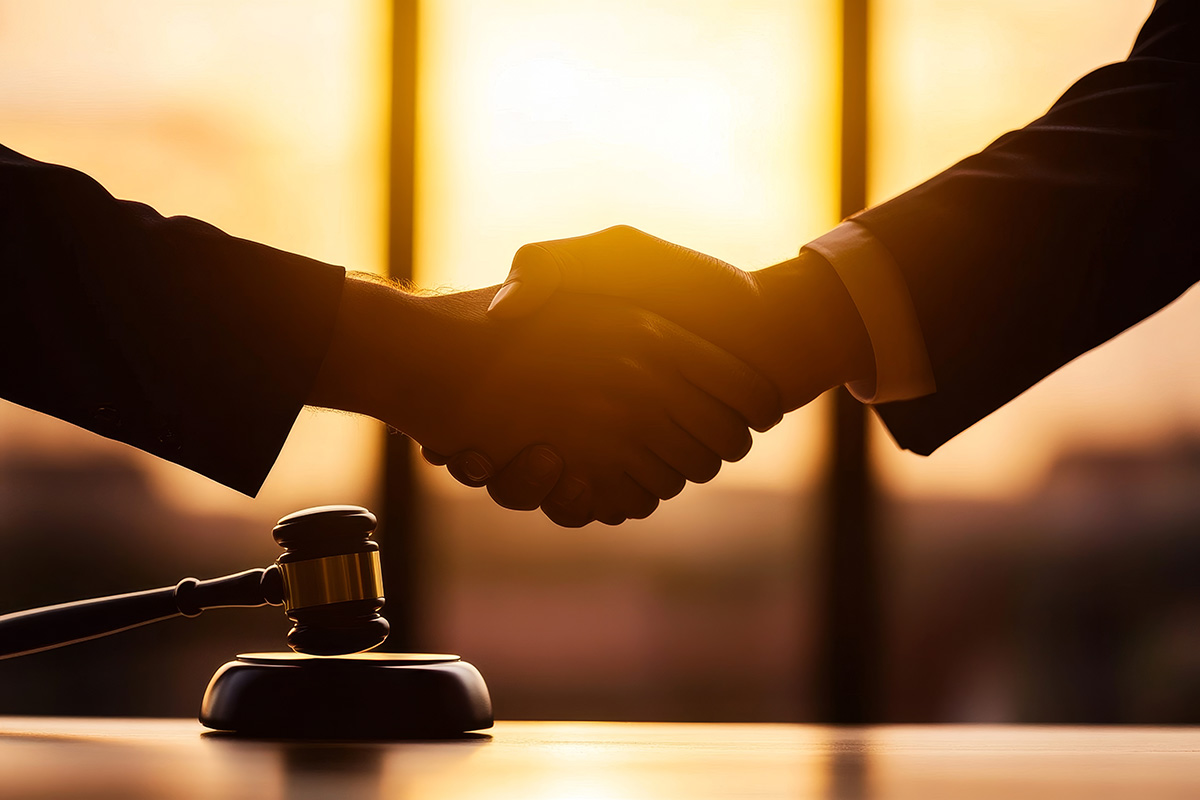 Two Hands Shake Front Gavel Legal Agreement